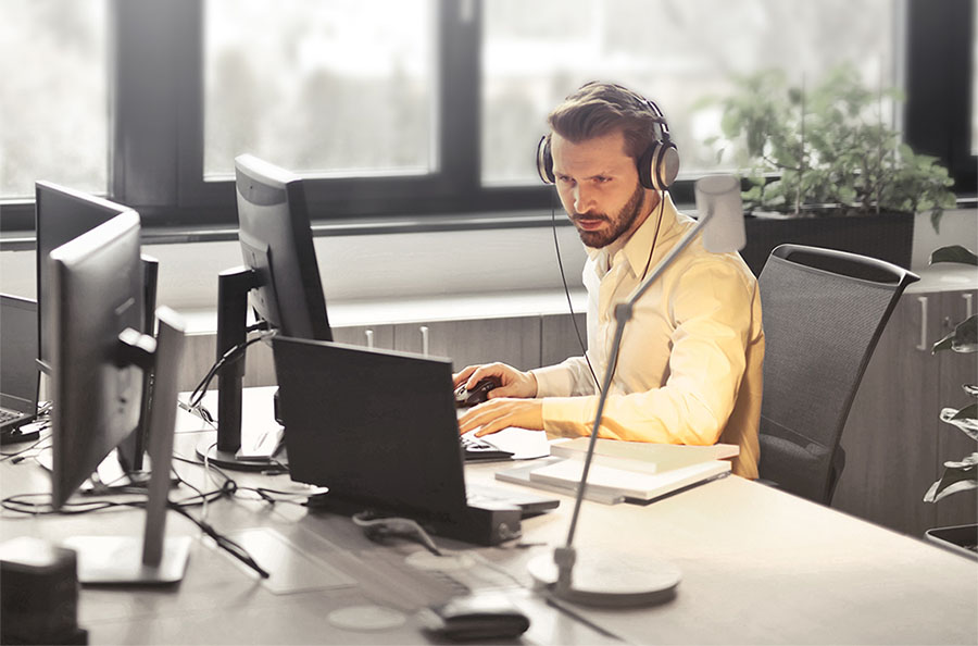 man looking on his desktop