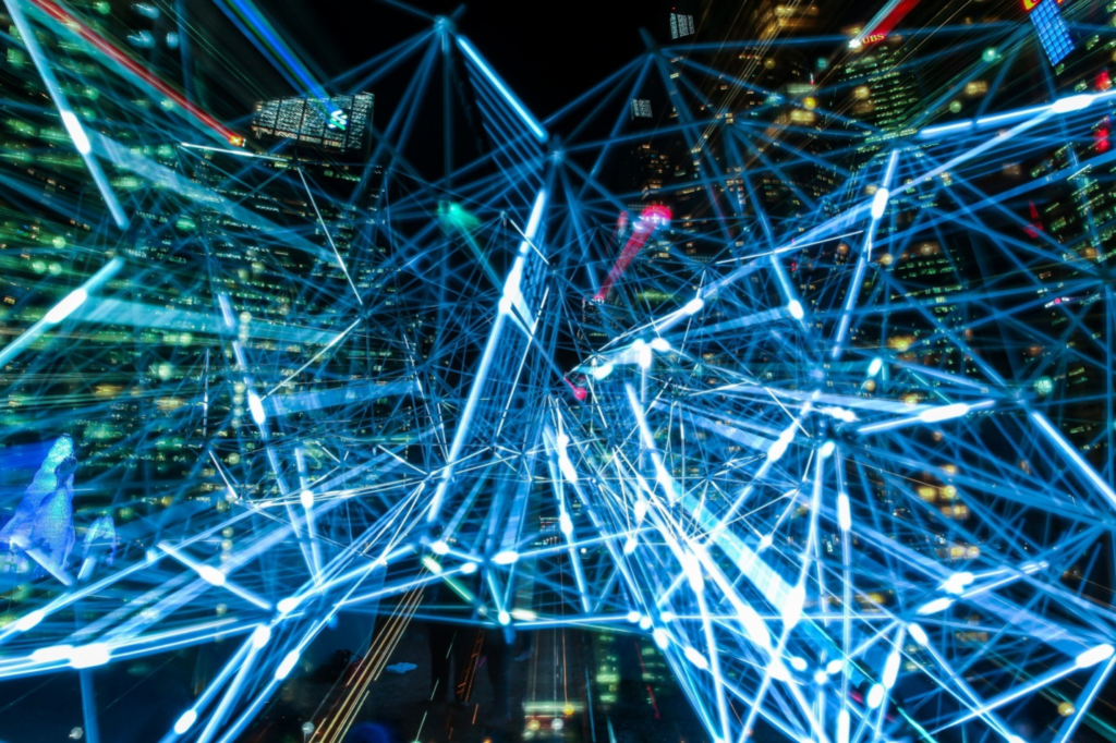 Bright blue futuristic lights with tall buildings in the background