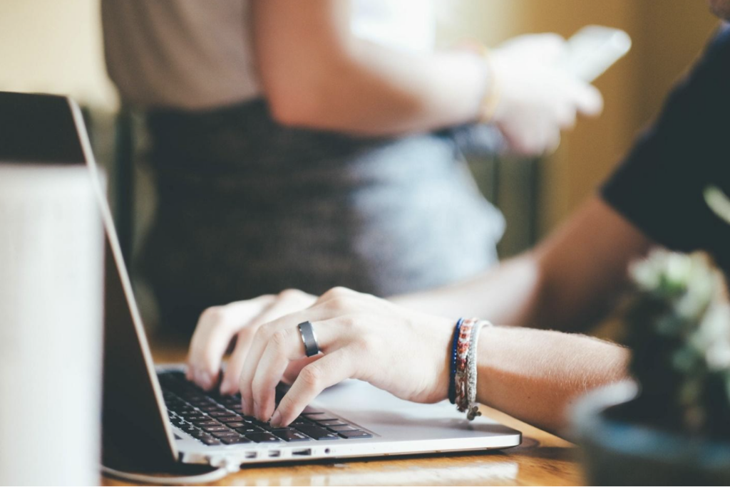 a person typing on a laptop