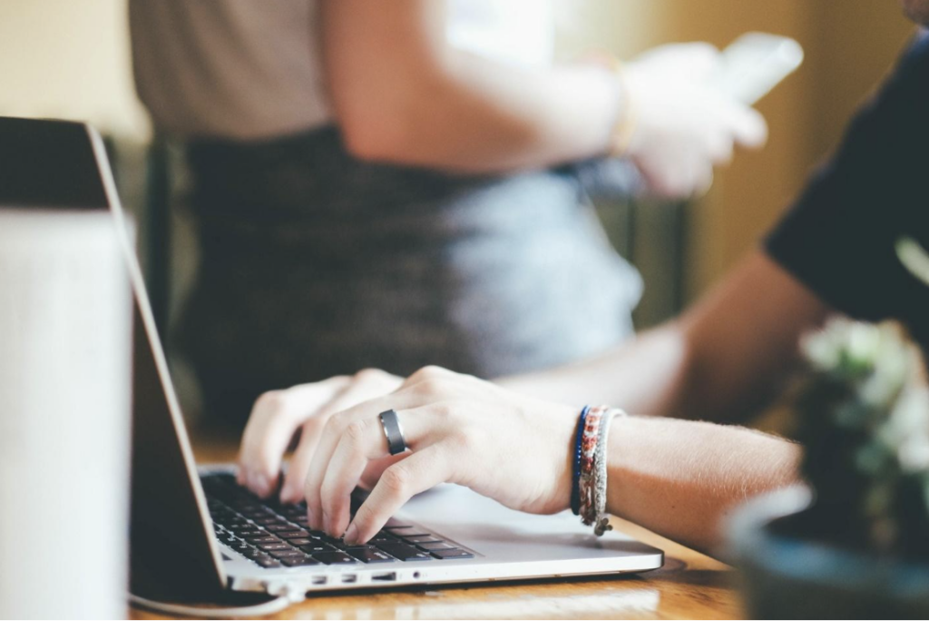 a person typing on a laptop 